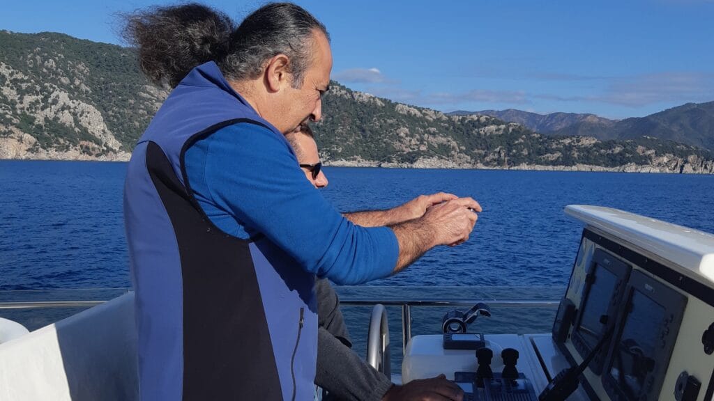 Marine surveyor conducting helm electronics and navigation equipment inspection during an underway sea trial